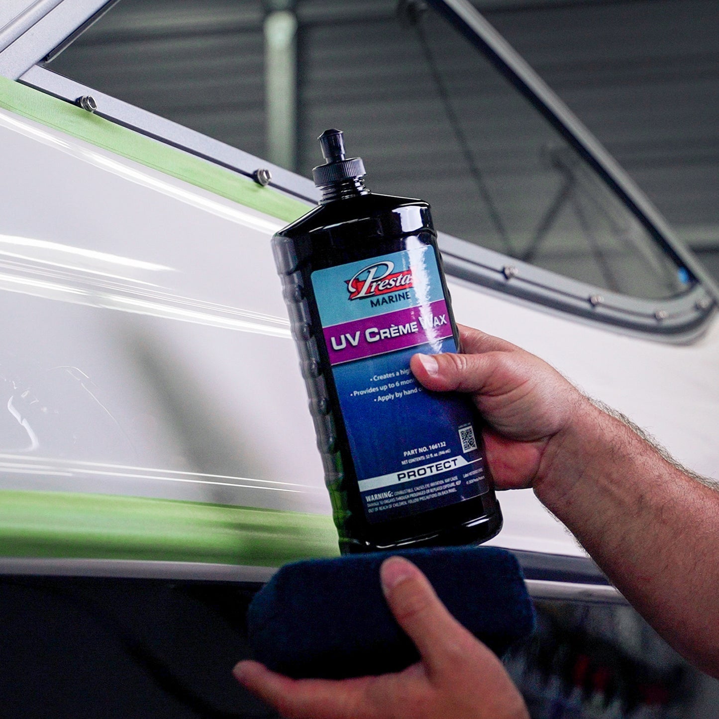 A person holding a bottle of UV Crème Wax
