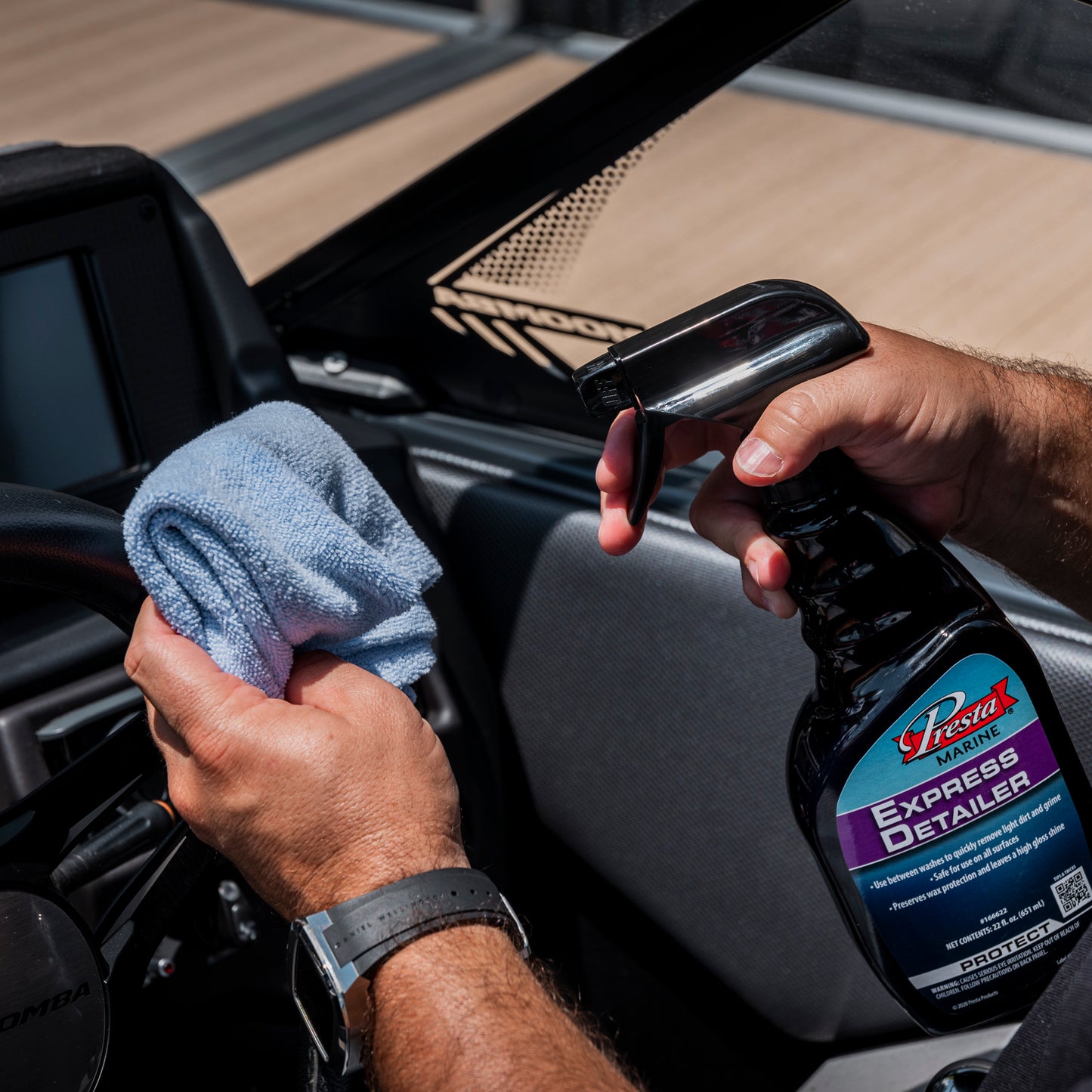An individual applying Presta Marine Express Detailer onto a blue cloth.